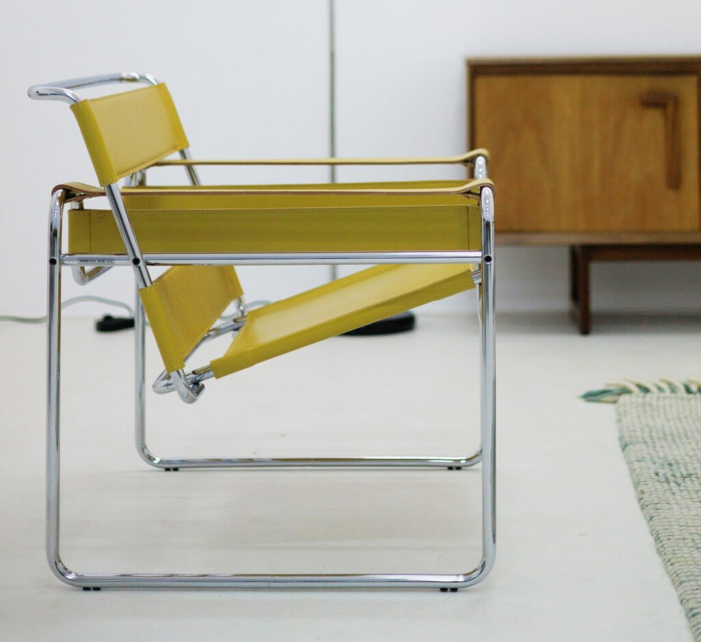 Yellow Wassily-style leather and chrome lounge chair, Bauhaus inspired modern accent chair in minimalist interior. (Accent Leather Chairs)